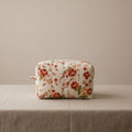 White hand-quilted hibiscus floral cosmetic bag with vertical stitching