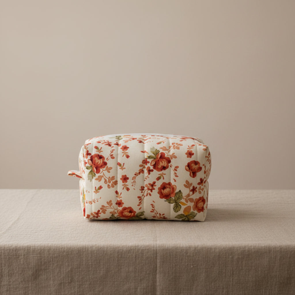 White hand-quilted hibiscus floral cosmetic bag with vertical stitching