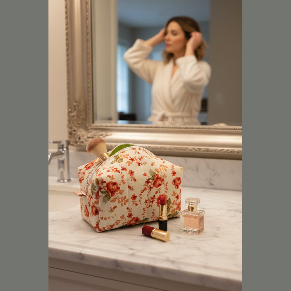 Open lime green lined floral makeup bag on bathroom counter with lipstick