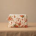 Closed white hibiscus floral quilted pouch with vertical stitching