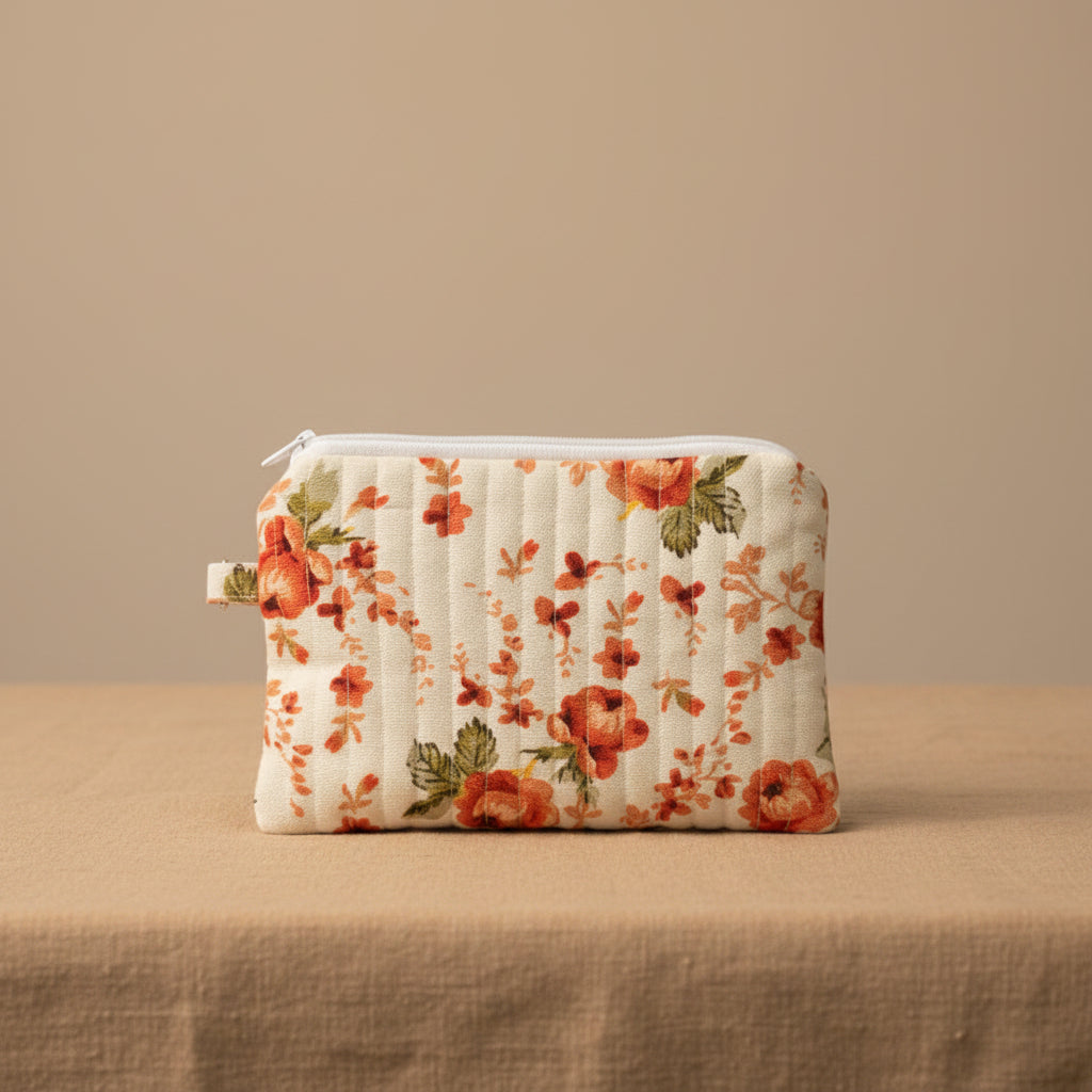 Closed white hibiscus floral quilted pouch with vertical stitching