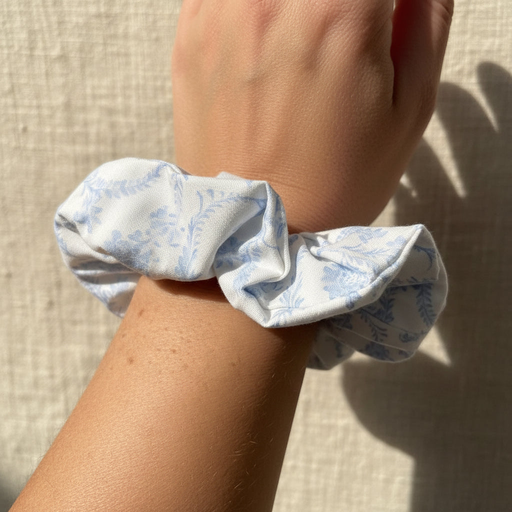 White light blue floral scrunchie worn as a wrist bracelet