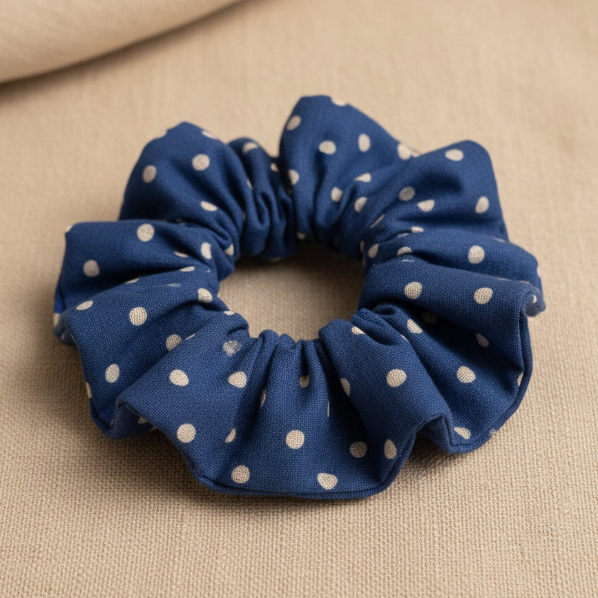 Close-up of gathered blue dotty cotton scrunchie showing ruffled texture