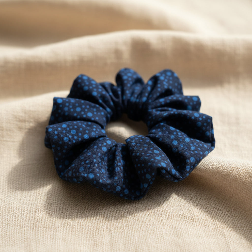 Close-up of navy blue dotted cotton hair scrunchie texture