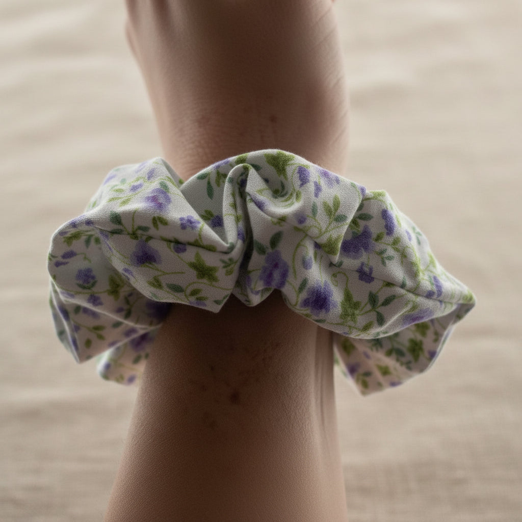 White cotton scrunchie with tiny lilac floral print on the wrist