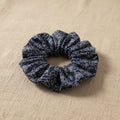 Close-up of gathered navy blue floral hair scrunchie