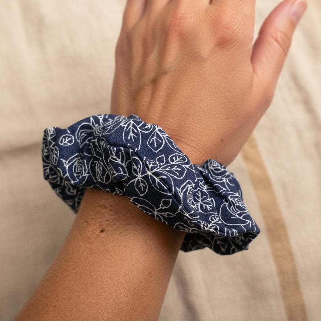 Navy rose cotton scrunchie worn as a wrist bracelet