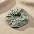 Minted with Dots handmade cotton scrunchie in sage green with multi-colored polka dots