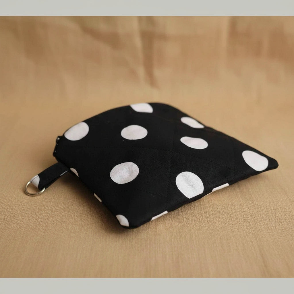 Black polka dot quilted pouch with silver key ring detail