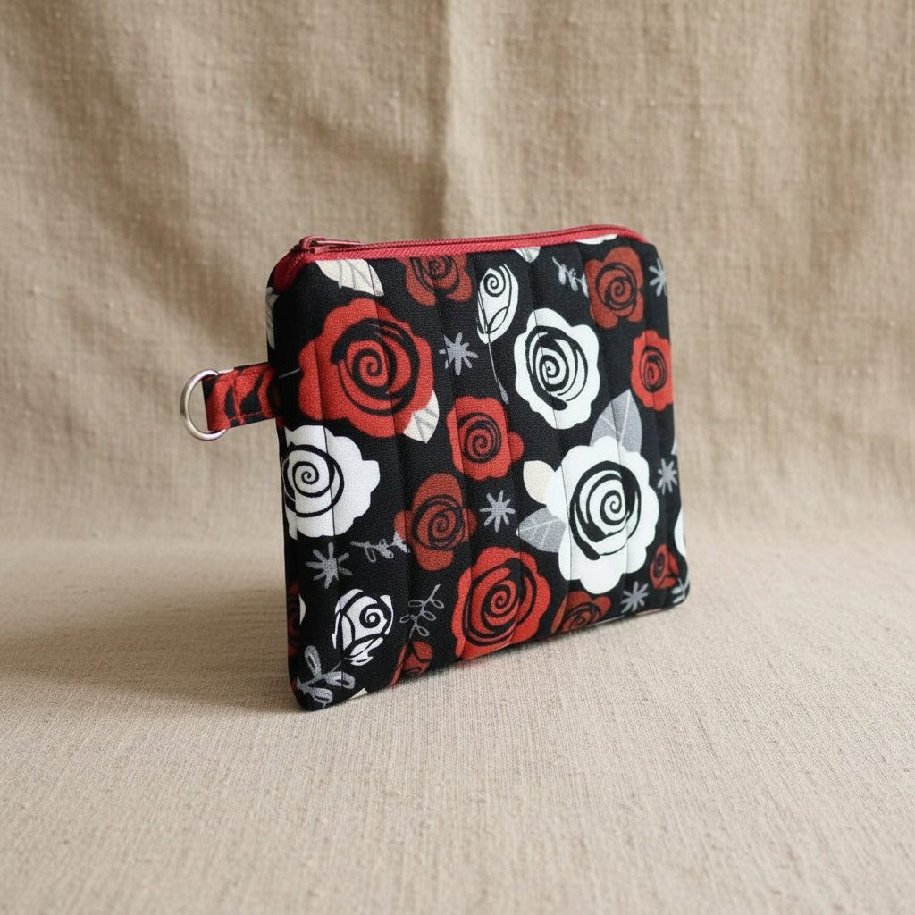 Handmade black quilted cosmetic bag with red zipper and rose pattern