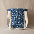 Navy blue hand quilted tote bag with white seashell print and cream handles