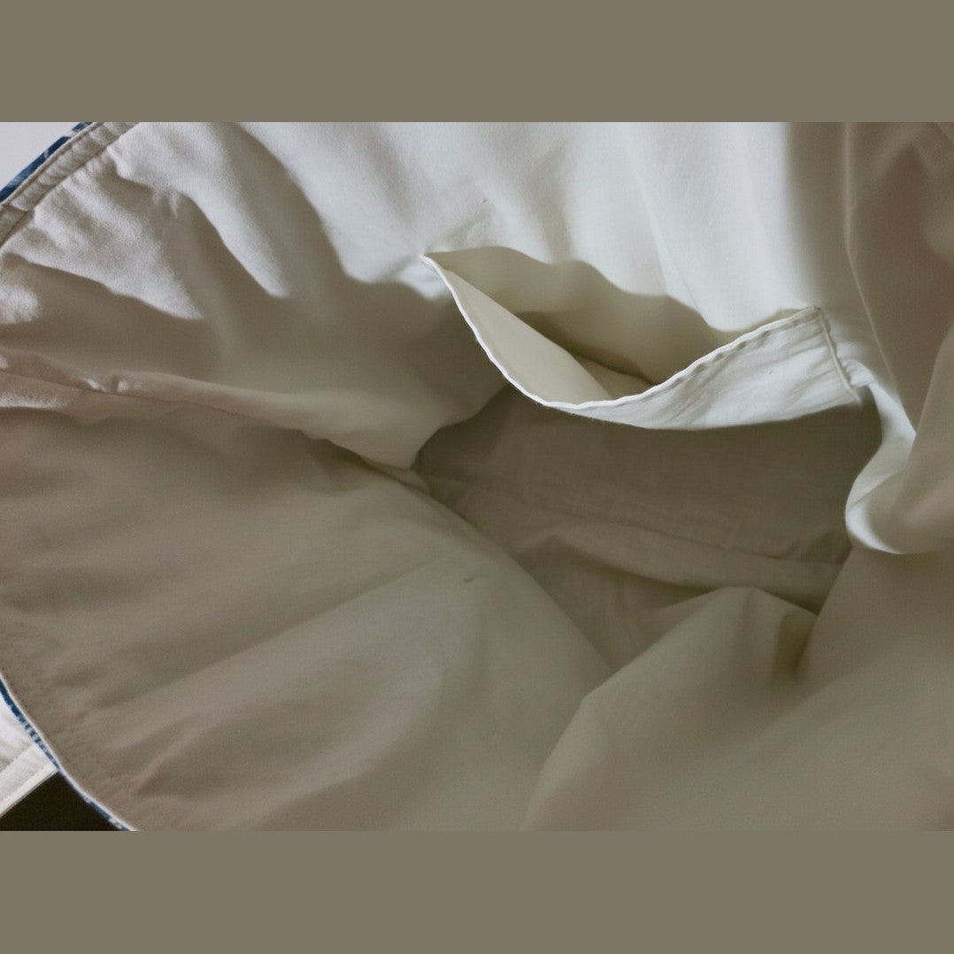 Cream cotton interior lining of navy shell print tote with internal pocket