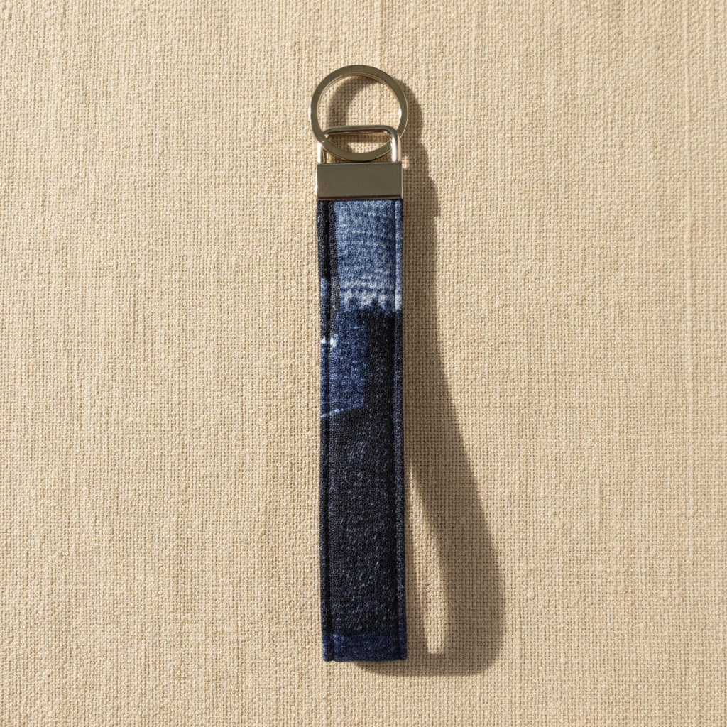 Navy denim wristlet strap with brushed metal bar and split ring
