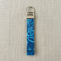 Blue watercolor floral cotton wristlet strap with silver D-ring