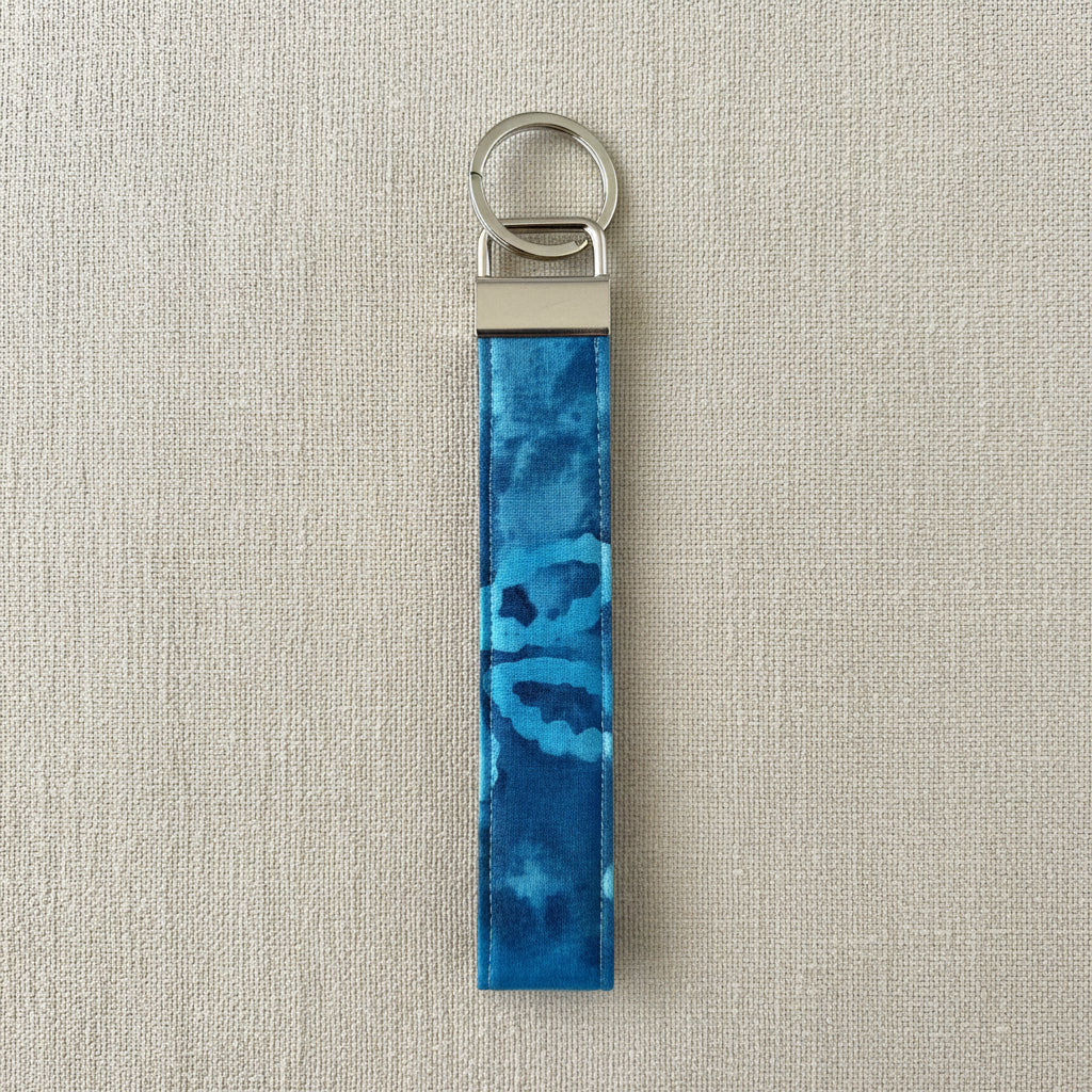 Blue watercolor floral cotton wristlet strap with silver D-ring