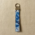 Blue tie-dye cotton wristlet strap with brass hardware