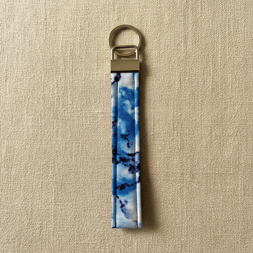 Blue tie-dye cotton wristlet strap with brass hardware