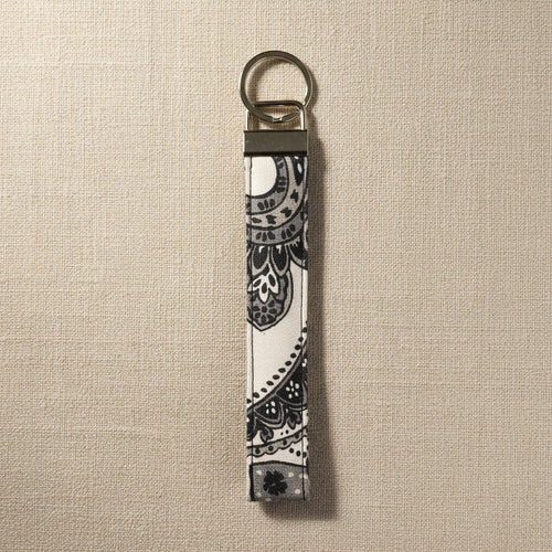 Gray and white floral cotton wristlet strap with silver split ring
