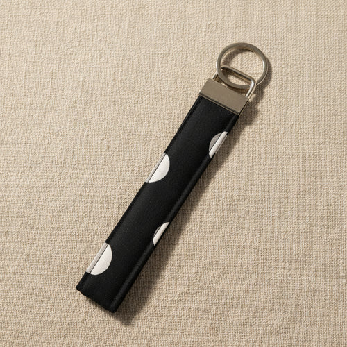 Black and white polka dot hand-quilted wristlet strap with silver D-ring hardware