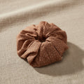Speckled dusty rose handmade scrunchie close-up on linen